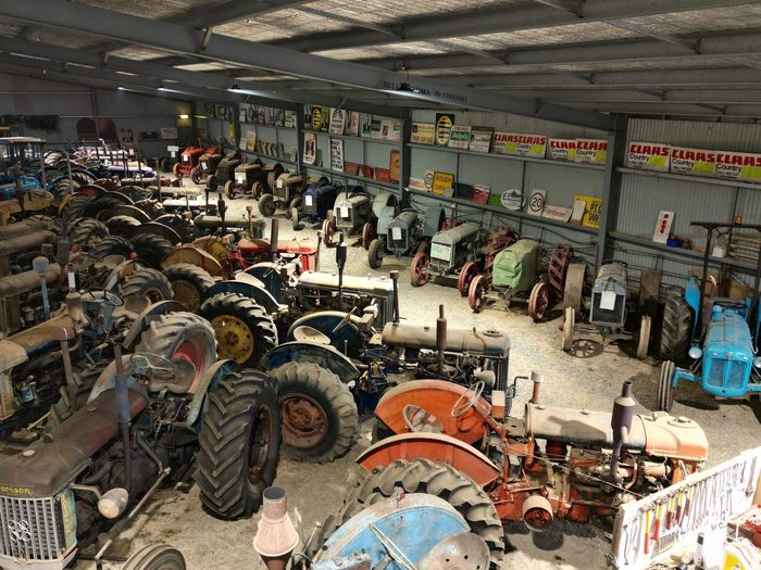 Tractors packed in close under the shed roof