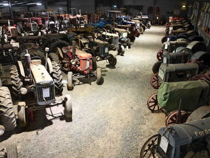 Rows of tractors filling the shed, parked nose to tail down both sides