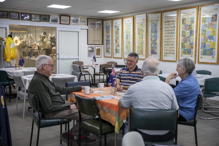 Visitors sitting down together for tea and biscuits in the reception room