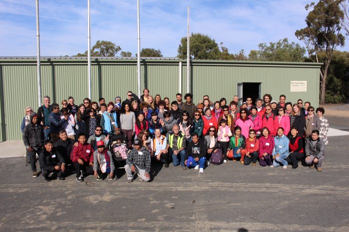 A large tour group gathered outside the museum