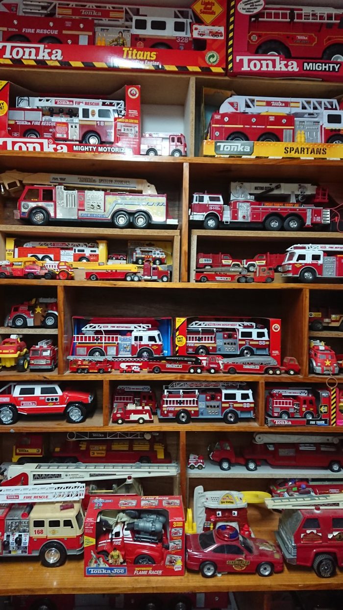 Shelves stacked with toy fire engines from floor to ceiling